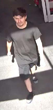 Camera footage photo of kidnapper wearing all black t-shirt, shorts and shoes. 